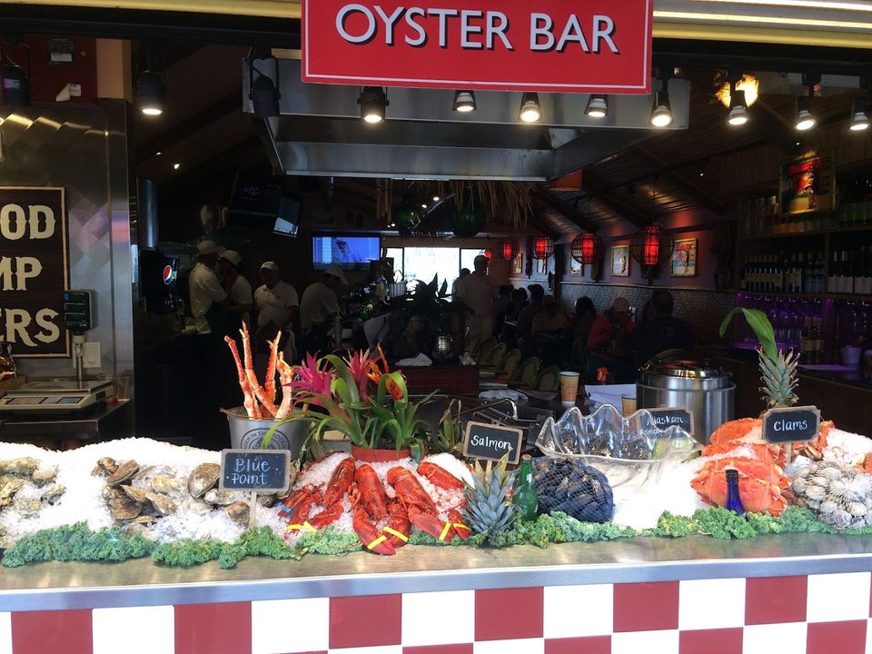 Seafood dishes on a restaurant table near the window.