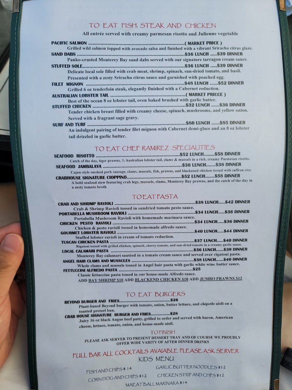 Printed menu beside a cocktail glass.